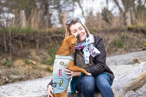 dog kissing mom in a photoshoot at a beach in Mississauga.