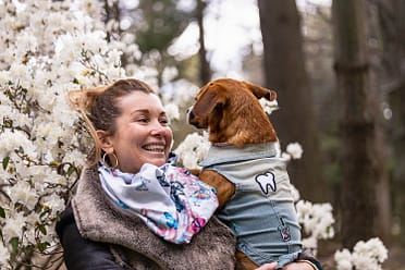 mom smiling in a puppy photoshoot in Mississauga, Ontario.