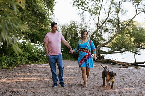 humans walking their dog at a pet photo session.