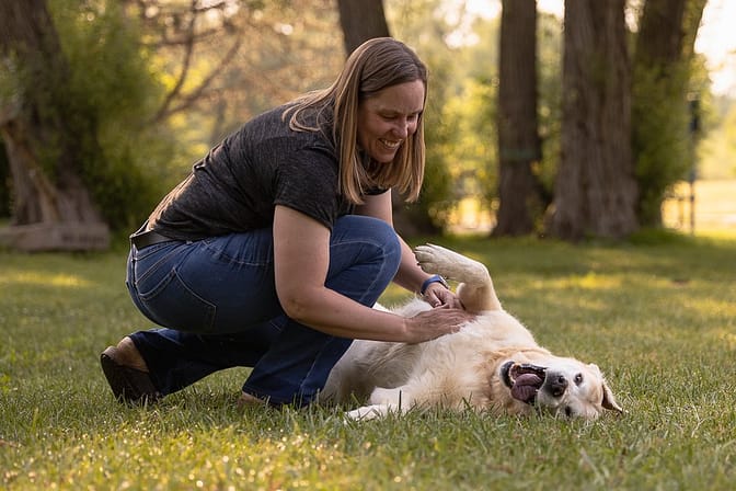 human playing with a dog in Lowville Park, Burlington Ontario