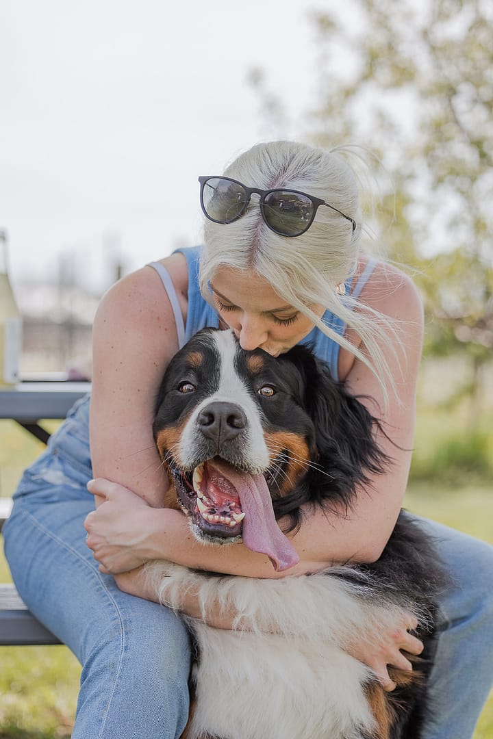 mom kissing a dog at Hounds Of Erie Winery