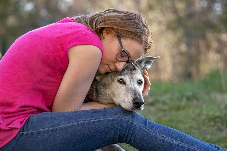 family pictures with dogs in Burlington, ON human hugging her dog at an end of life pet photoshoot in Burlington, ON