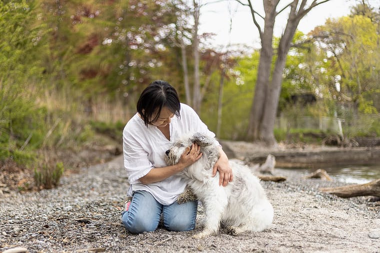 a dog mom hugging her dog at an end of life dog photo shoot session.