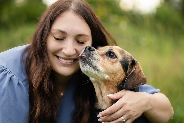 Dog kissing dog mom at an end-of-life pet photoshoot session.