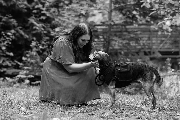 Dog mom looking at her heartfelt dog at an end-of-life dog photo session at Lowville Park.