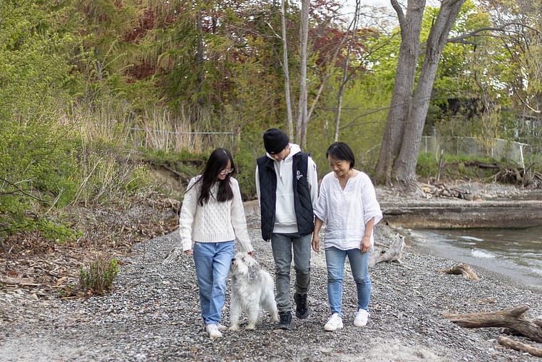 a family image walking with their dog