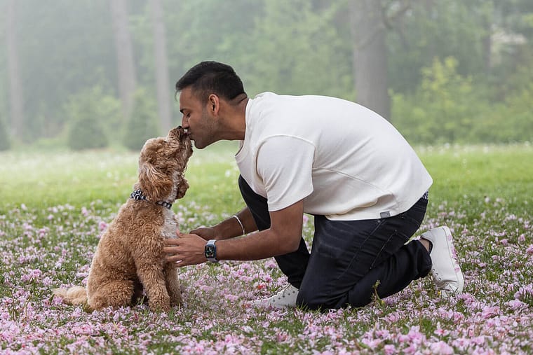dog dad kissing a dog during a dog photoshoot at Gairloch Gardens.